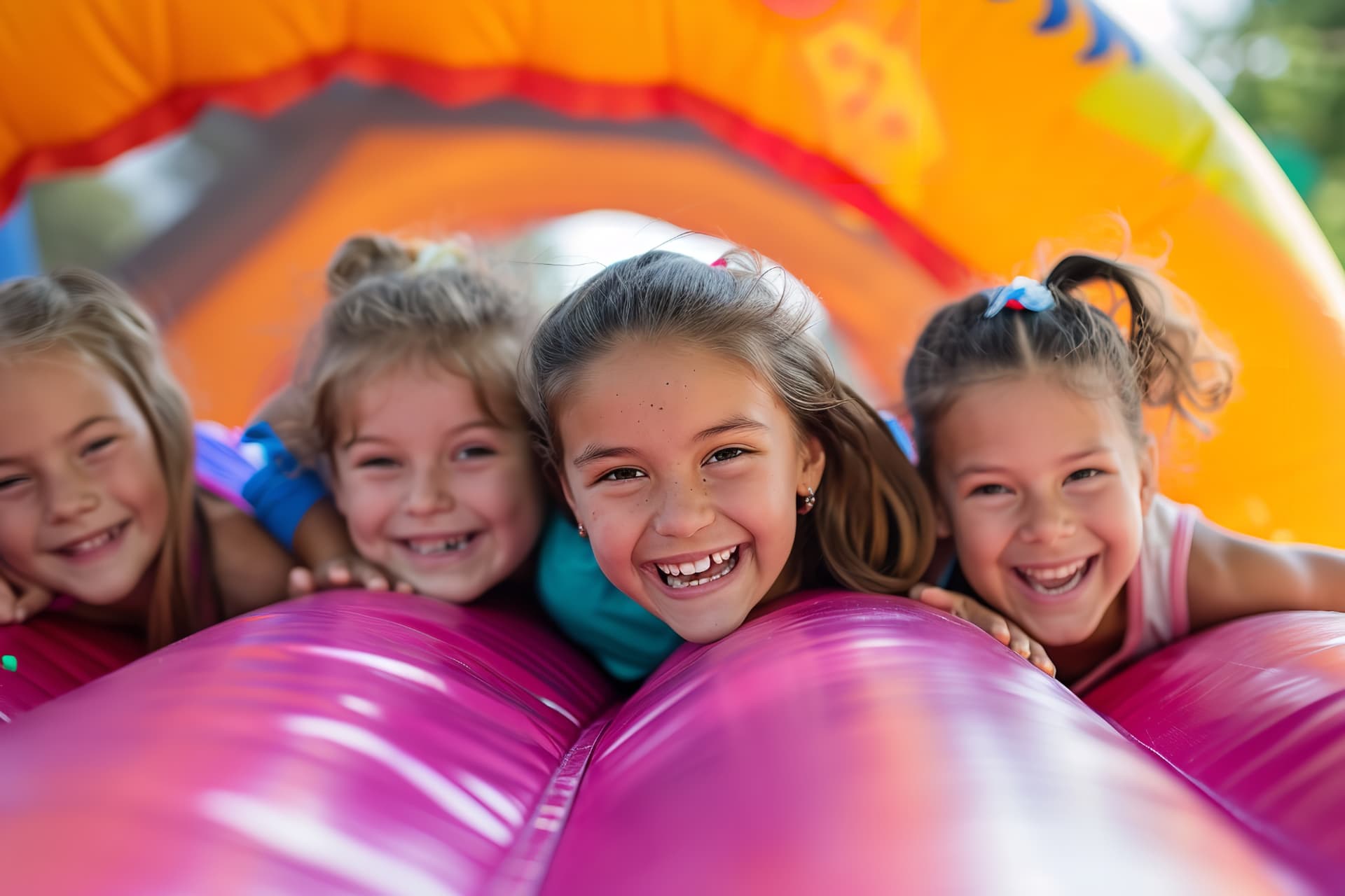 Children enjoying a pink and purple inflatable — party rental delivered in Fort Myers Beach, FL
