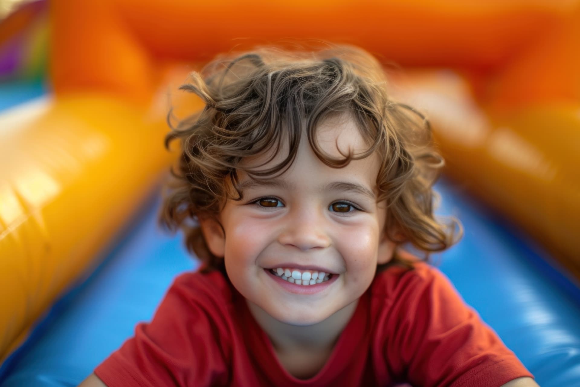 Smiling child playing inside a colorful inflatable — party rental delivered in Buckingham, FL
