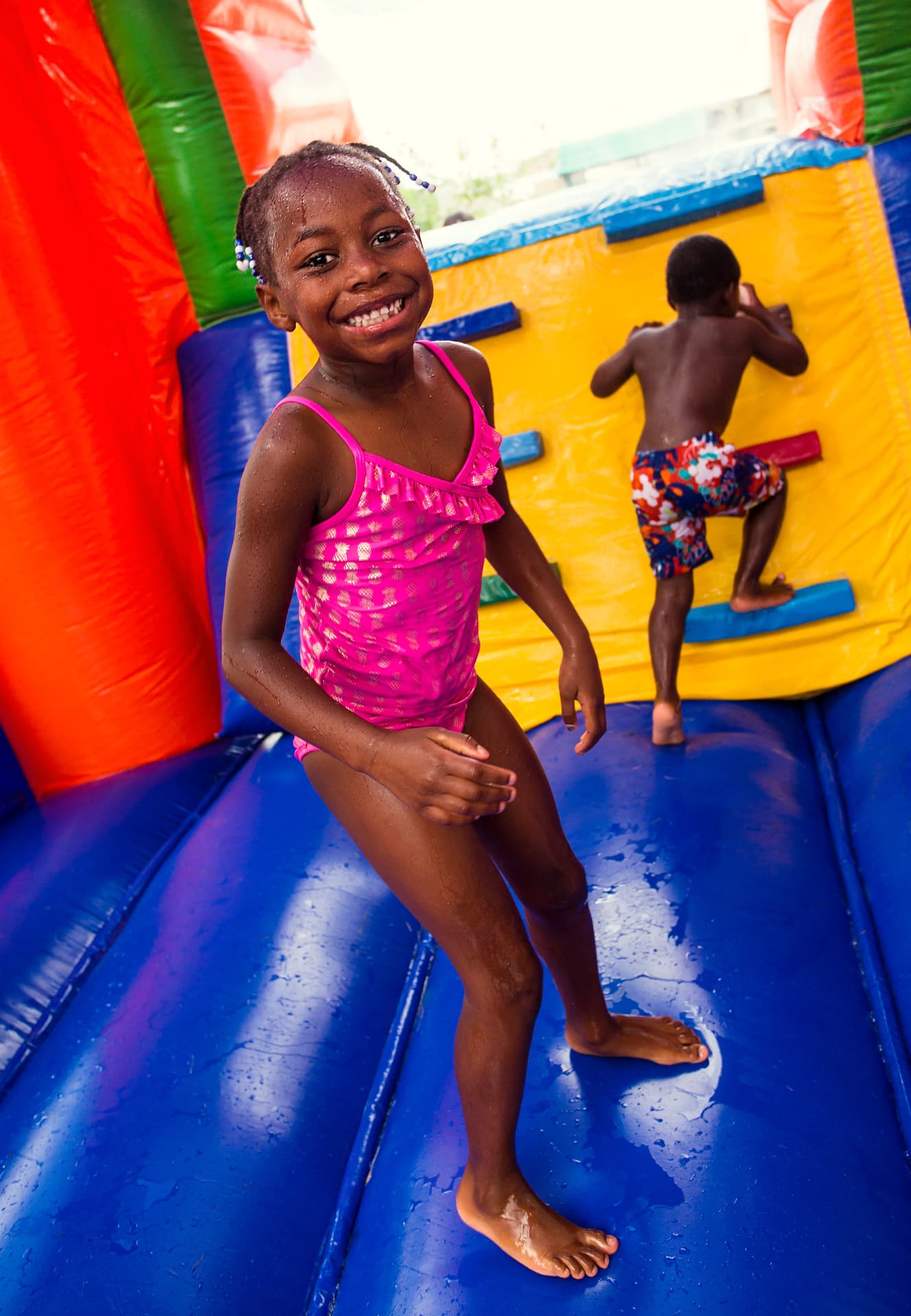 Children playing inside a colorful inflatable slide — party rental delivered in Lehigh Acres, FL