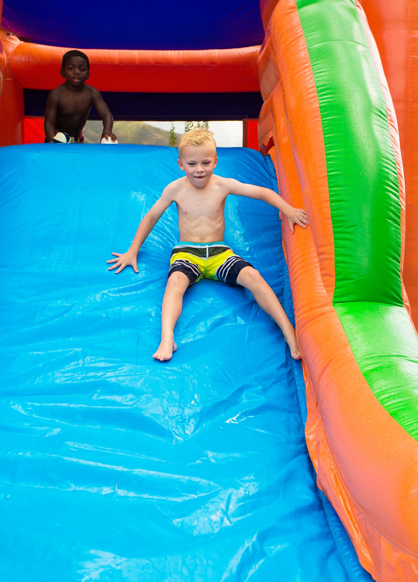 Kids enjoying a colorful water slide — party rental delivered in Alva, FL